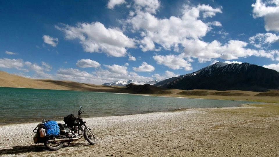 A motorcycle beside a high-altitude lake